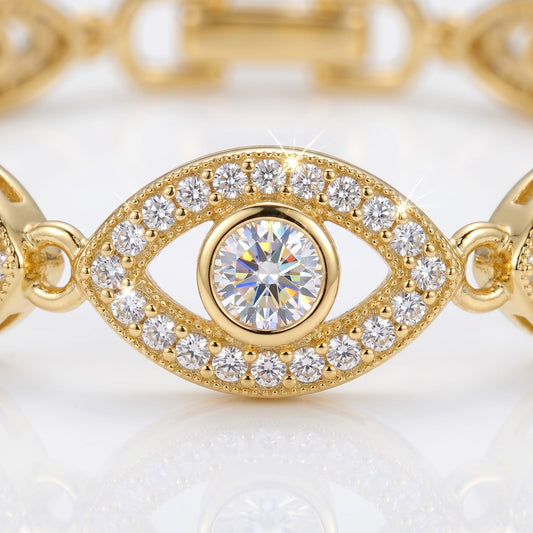Gold bracelet with diamond-encrusted eye design on a light background