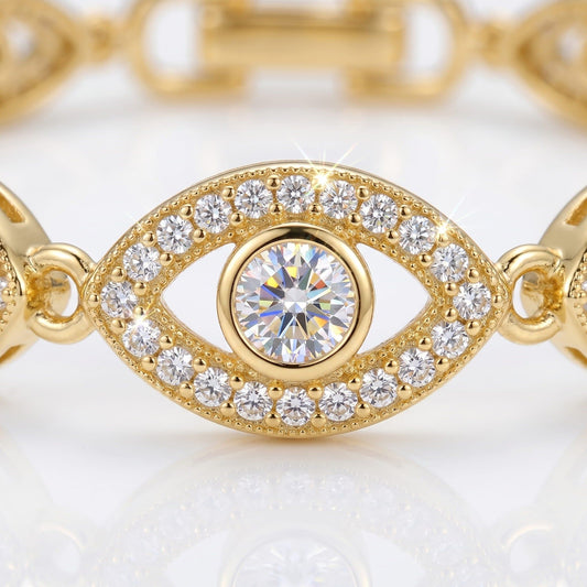 Gold bracelet with diamond-encrusted eye design on a light background