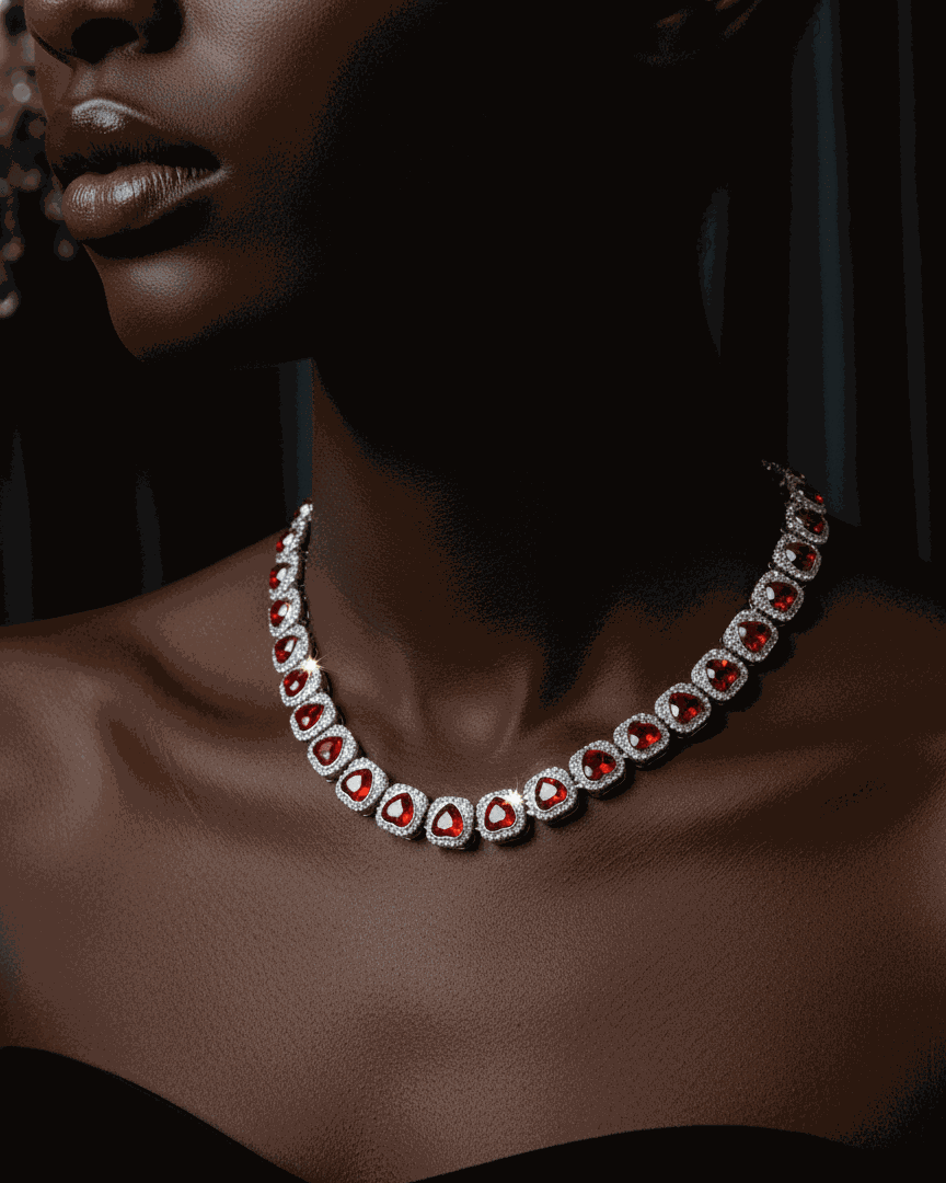 Elegant necklace with red gemstones on a model against a dark background, featuring the Hypenation brand.