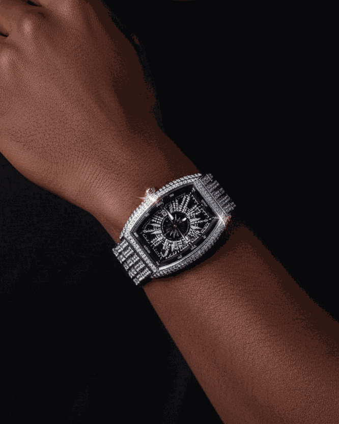 Man wearing a luxurious watch on a dark background