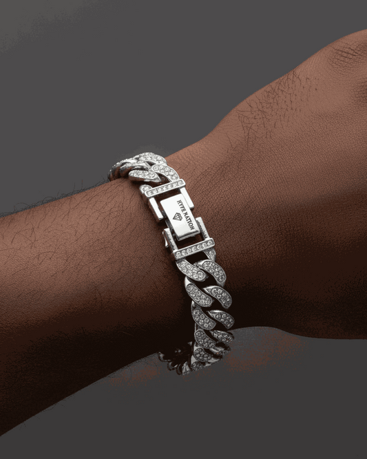 Silver chain bracelet on a wrist against a dark background