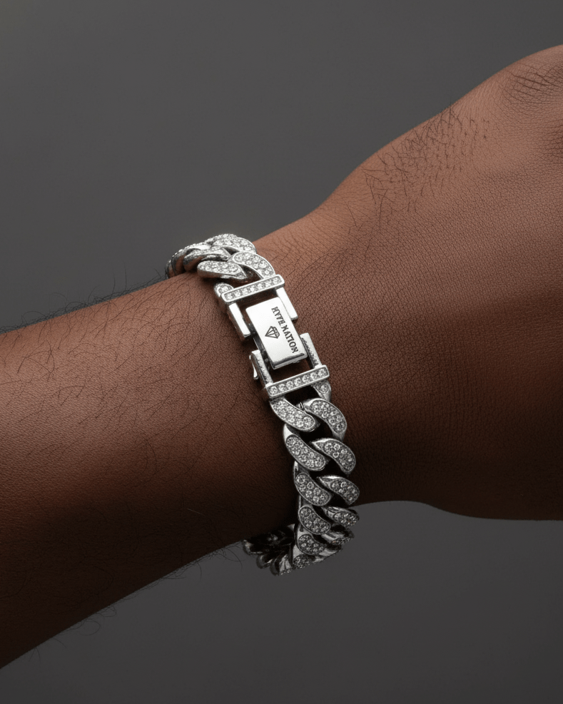 Silver chain bracelet on a wrist against a dark background